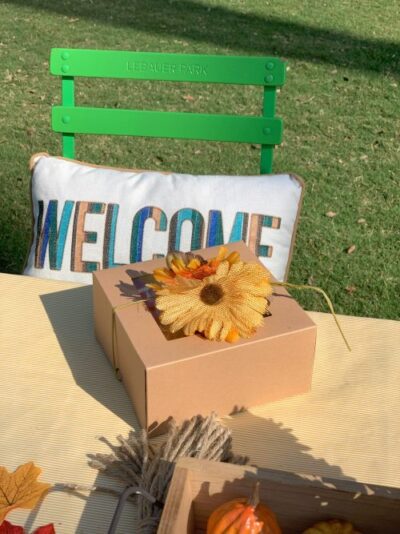 a box lunch with a flower on top