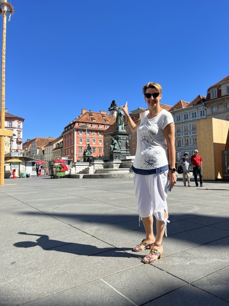 a woman posing in a European city plaza