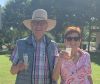 An older couple pose smiling